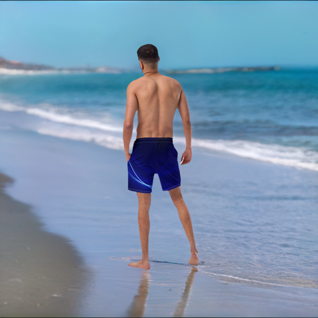 A man standing on the beach in a bathing suit.